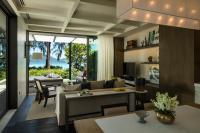 a living room with a couch and a table at Rosewood Phuket in Patong Beach
