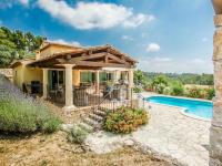 a home with a swimming pool and a house at La Bastide des Cairns in Seillans