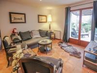 a living room with a couch and a table at La Bastide des Cairns in Seillans