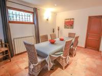 a dining room with a table and chairs at La Bastide des Cairns in Seillans