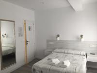 Postel nebo postele na pokoji v ubytování Hostal Lar