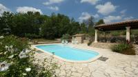 a swimming pool in a garden with a pavilion at La Bastide des Cairns in Seillans