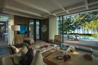 a living room with a couch and a table at Rosewood Phuket in Patong Beach