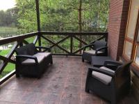 a patio with chairs and a fence and trees at Park Hotel Borvikha in Pilichki