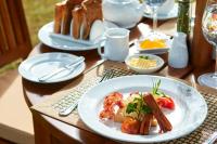 a table with a plate of food on a table at Manor House Bandarawela By Seven Angels in Bandarawela