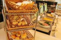 a buffet line with baskets of bread and other foods at Oak Ray Elephant Lake in Sigiriya