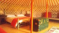 a bedroom with a bed in a yurt at Yurte in Langa in Bosia