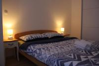 Posteľ alebo postele v izbe v ubytovaní Apartmani Palmas Rijeka
