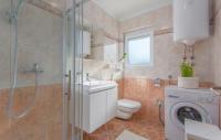 a bathroom with a toilet sink and a shower at Silver Holiday House in Poreč