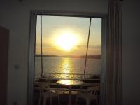 a view of the sunset from a room with a window at Galini Studios and Apartments in Lassi