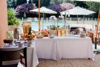 a table with a buffet of food on it at Golf Hôtel de Valescure &amp; Spa NUXE in Saint-Raphaël