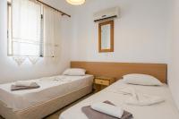 A bed or beds in a room at Kardamena Holiday Apartments