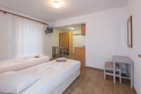 A bed or beds in a room at Kardamena Holiday Apartments