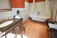 a bathroom with a tub and a sink and a bath tub at La Grande Maison De Nans in Nans-les-Pins