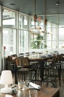 a dining room with a table with chairs and a chandelier at The Boathouse in Kennebunkport