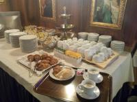 a table with a buffet of food and cups and plates at Antico Panada in Venice