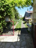 a woman sitting at a picnic table with a white dog at La Maison Rouge in Chauvigny