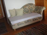 a couch with pillows on it in a room at Baby- und Kinderhof Aicherbauer in Seeham