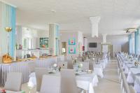 a dining room with white tables and white chairs at Hotel Pacific in Cattolica