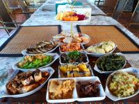 a table with a bunch of different types of food at Light and Shadow B&amp;B in Yuanshan