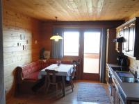 a dining room with a table and a window at Baby- und Kinderhof Aicherbauer in Seeham