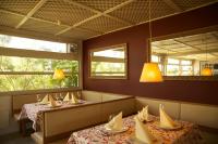 a dining room with two tables and a mirror at Storchencamp Gästehaus Purbach in Purbach am Neusiedlersee