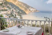 a white table with a view of the ocean at Hotel Poseidon in Positano