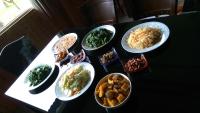 a table with several bowls of food on it at Seasons Inn in Jiaoxi