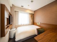 Natural Hot Spring SUPER HOTEL Kumamoto Chamber of Commerceにあるベッド