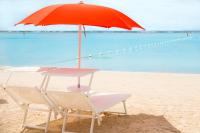 a chair and an umbrella on the beach at Boca Beach Residence hotel in Boca Chica