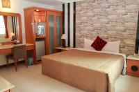 a hotel room with a bed and a desk and a chair at Li Tang in Baihe