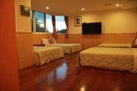 a room with two beds and a flat screen tv at Li Tang in Baihe
