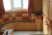 a bathroom with a bath tub with a window at Li Tang in Baihe