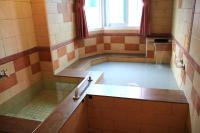a bath room with a tub filled with water at Li Tang in Baihe