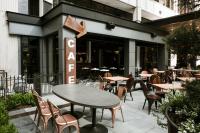 a patio with tables and chairs in front of a restaurant at Bobby Hotel in Nashville