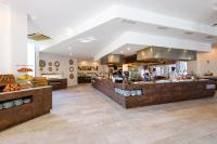 a large kitchen with two men preparing food at Aparthotel Tropic Garden in Santa Eularia des Riu