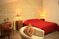 a bedroom with a red bed and a chair at Les chambres de Blanot in Blanot
