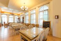 a dining room with tables and chairs and a chalkboard at Hasayaki Homestay in Dayi