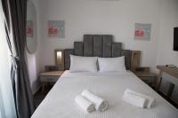 A bed or beds in a room at Amalia Rooms Sea View
