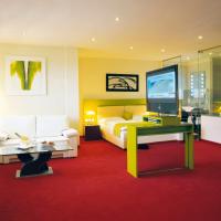 a bedroom with a bed and a tv and a couch at Hotel Restaurant Pusswald in Hartberg
