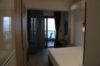 A bed or beds in a room at Amalia Rooms Sea View