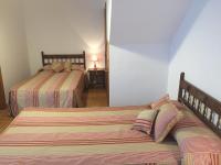 A bed or beds in a room at Hotel Rural Nova Ruta