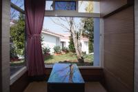 a window with a view of a yard at Guanziling Lin Kuei Yuan Hot Spring Resort in Baihe