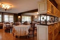 a dining room with white tables and chairs and a restaurant at Hostería de Guara in Bierge