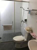 a bathroom with a shower and a toilet and a sink at Kuo Kuang Hostel in Hualien City