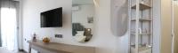 A television and/or entertainment centre at Amalia Rooms Sea View