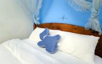 a blue elephant pillow sitting on top of a bed at sweet home B&amp;B in Hualien City