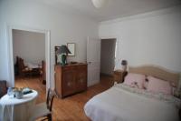 a bedroom with a bed with pink pillows and a table at Le Magnolia in La Rochefoucauld