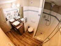 a bathroom with two sinks and a shower at Hôtel Les Arches in Saint-Lary-Soulan