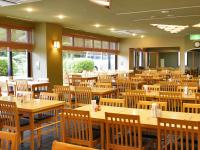 an empty restaurant with wooden tables and chairs at LiVEMAX Resort Atami Forest in Atami